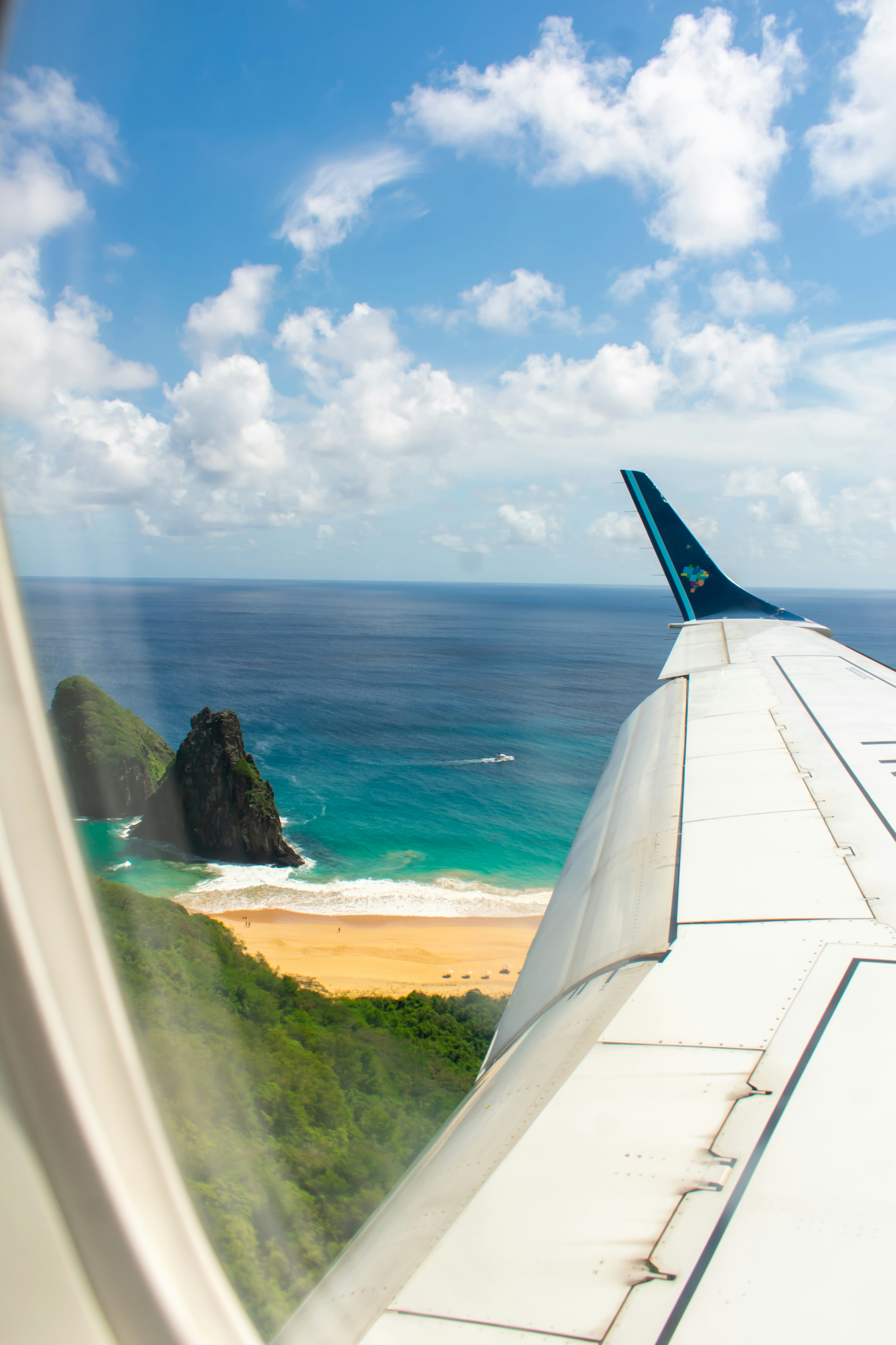 white airplane wing over the sea during daytime